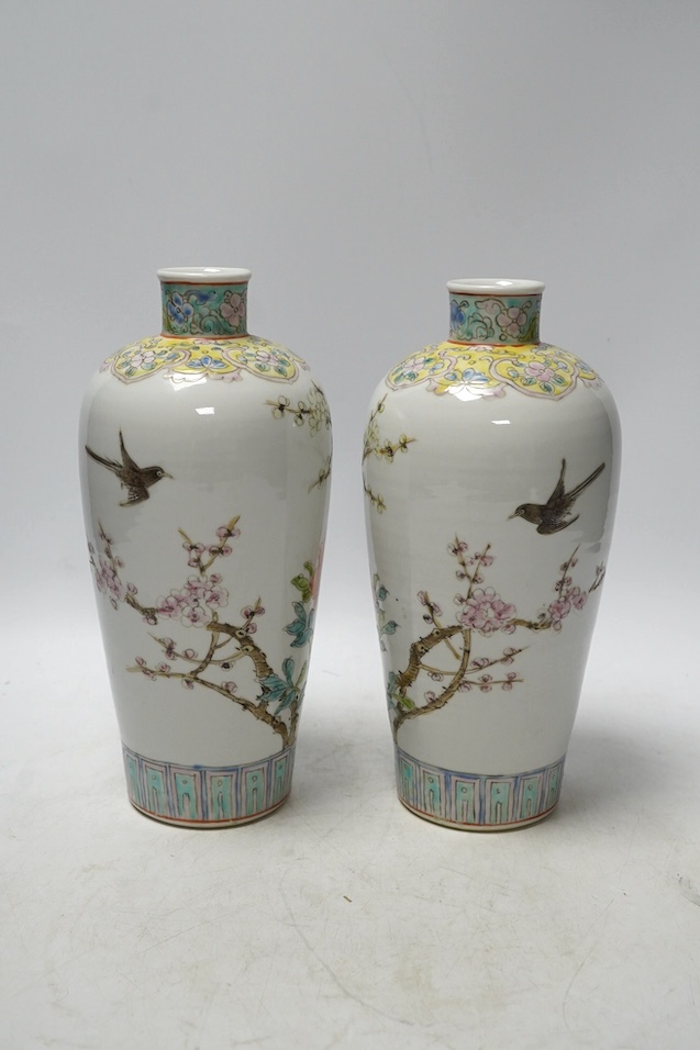 A pair of Chinese famille rose tapering vases, Qianlong mark but later, 23cm. Condition - good